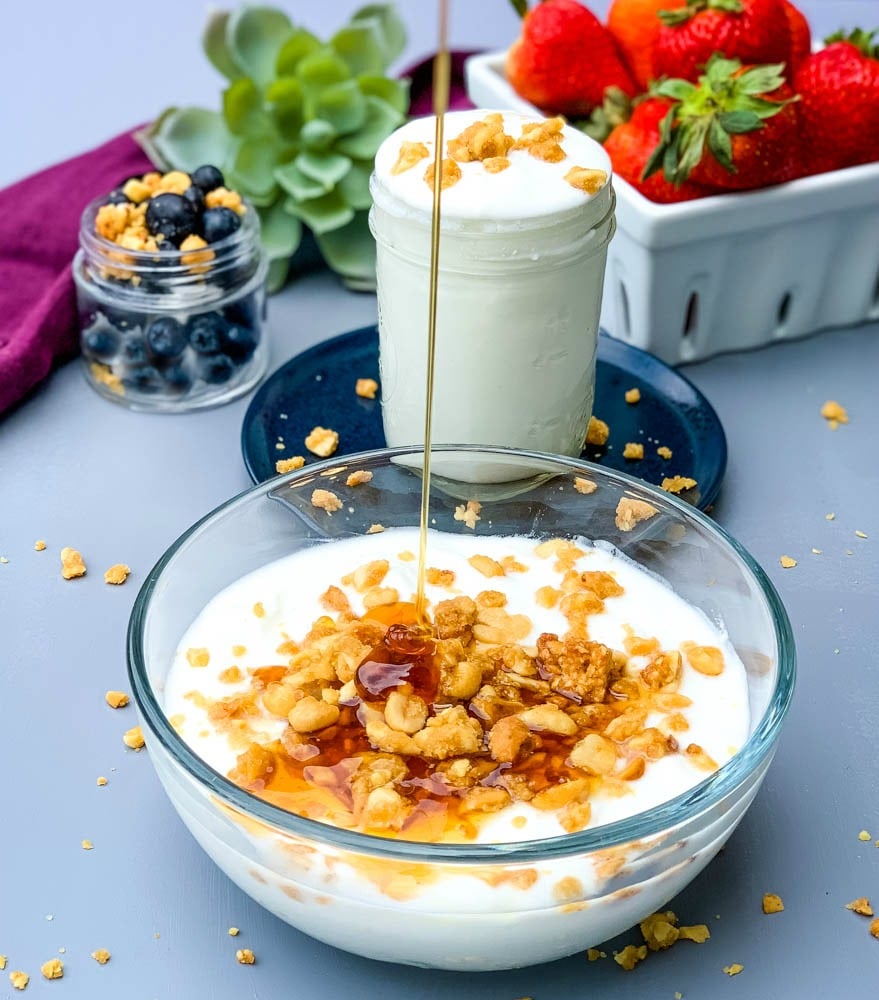 instant pot homemade yogurt in a glass bowl drizzled with honey