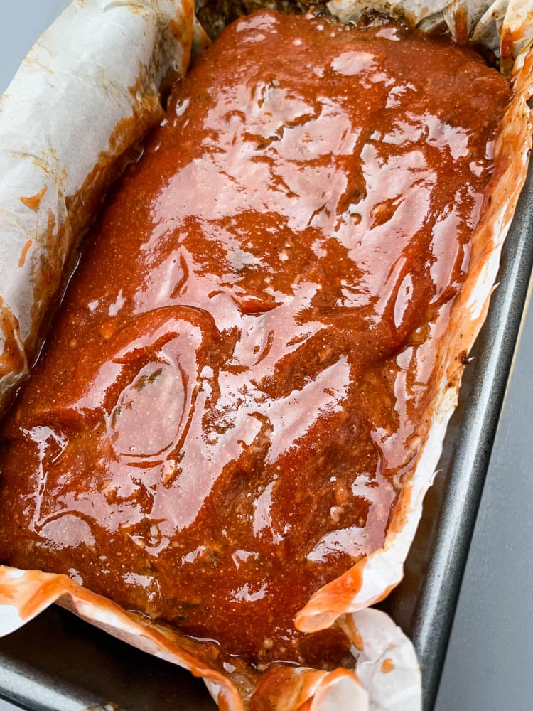 cooked keto meatloaf in a pan with glaze