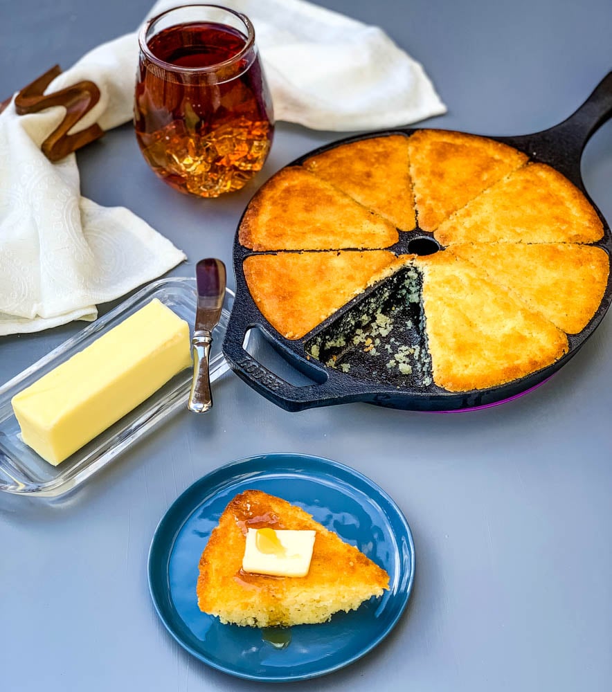 southern cast iron skillet cornbread on a plate and in a wedge pan with butter