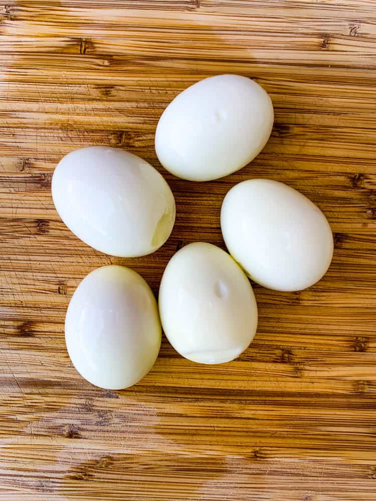 air fryer hard boiled eggs on a bamboo cutting board