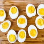 air fryer hard boiled eggs sliced on a bamboo cutting board