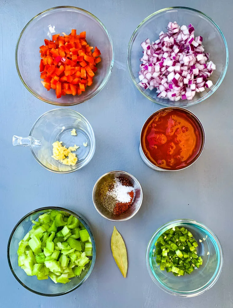 chopped red peppers, chopped onions, garlic, tomatoes, and celery in glass bowls