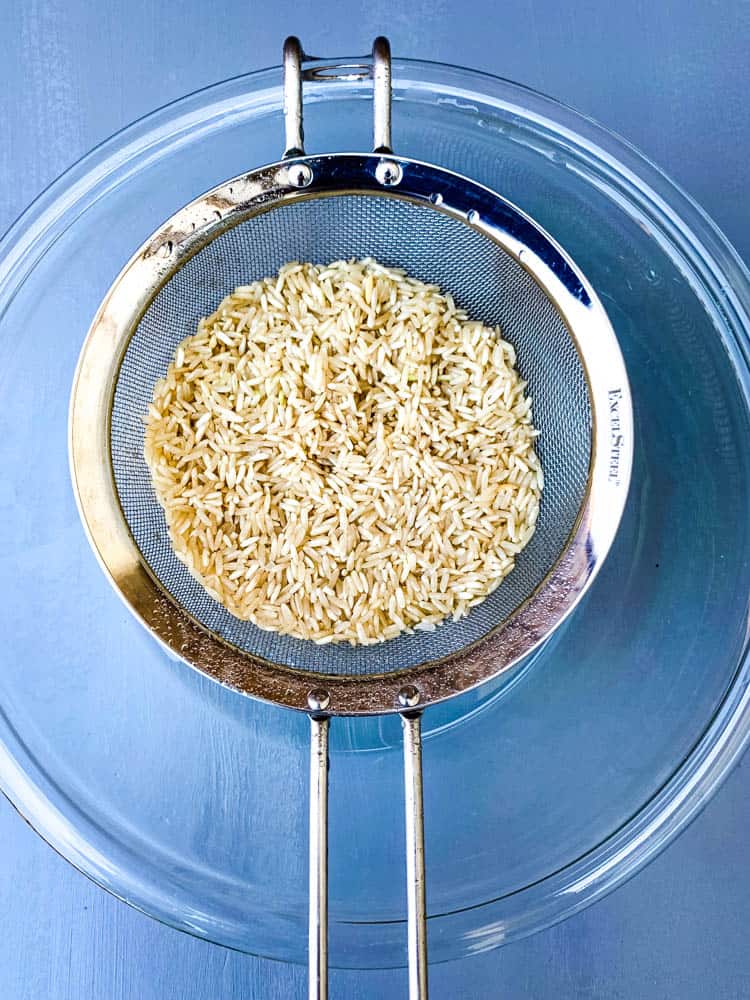 strained brown rice and a glass bowl