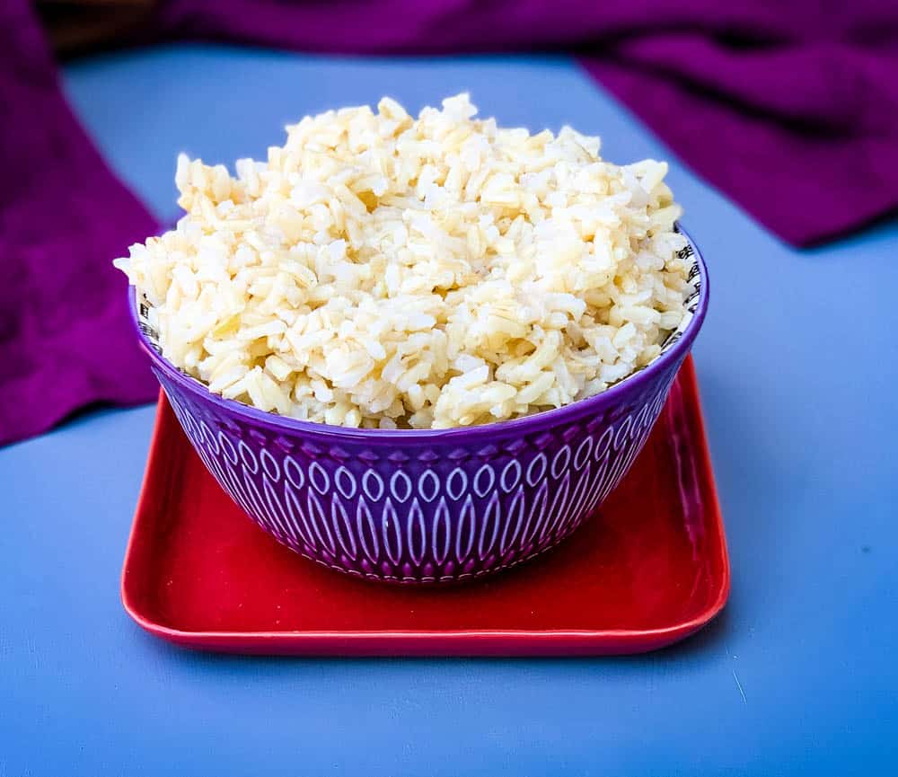 Instant Pot brown rice in a purple bowl