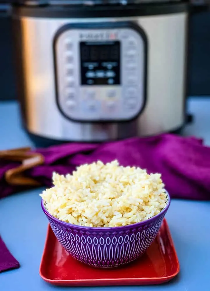 Instant Pot brown rice in a purple bowl