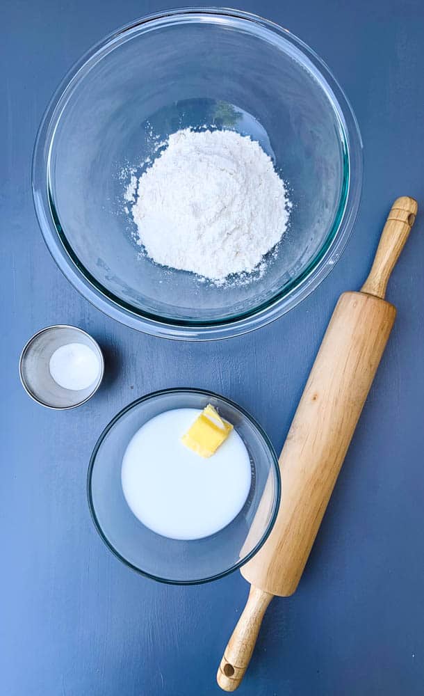 flour, melted butter and milk, and baking powder in bowls