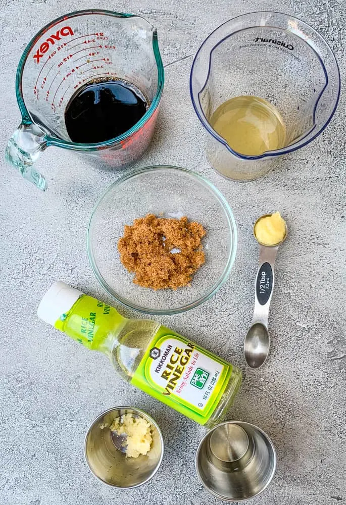 soy sauce, rice vinegar, brown sweetener, garlic, and ginger in bowls