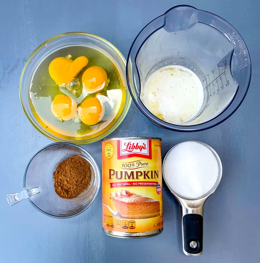 eggs, sweetener, pumpkin spice, and pumpkin in glass bowls