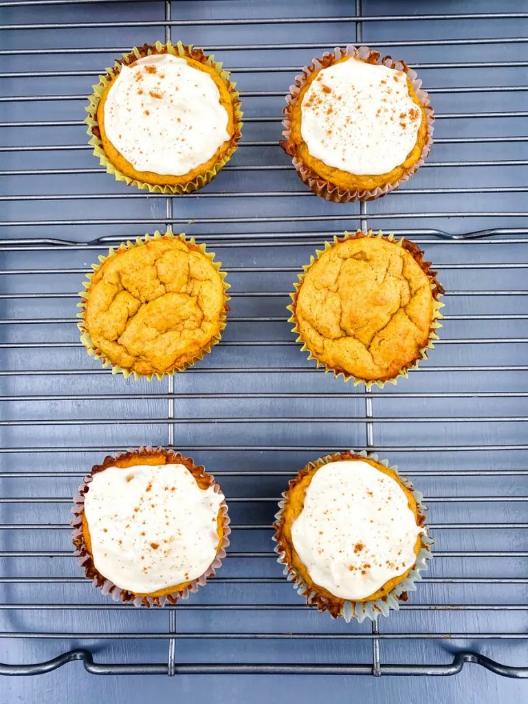 keto pumpkin muffins with cream cheese on a cooling rack