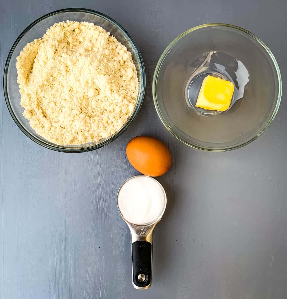 almond flour, butter, an egg, and sweetener in glass bowls