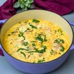 keto low carb zuppa toscana soup in a purple cast iron Dutch oven