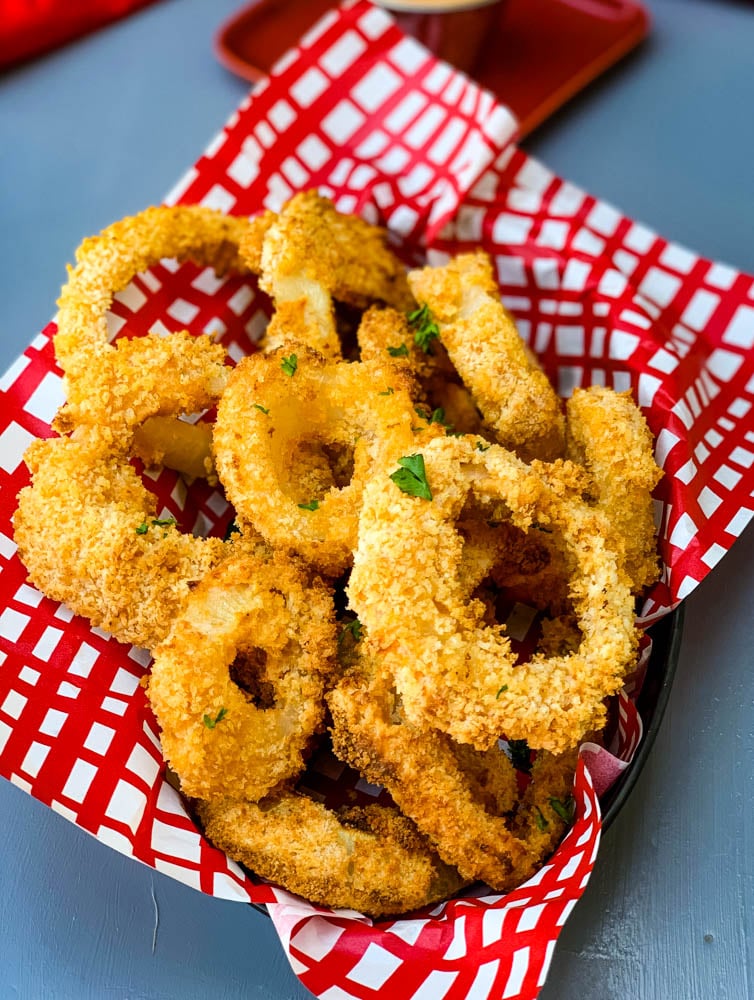 air fryer crispy onion rings in a bowl with a red wrapper