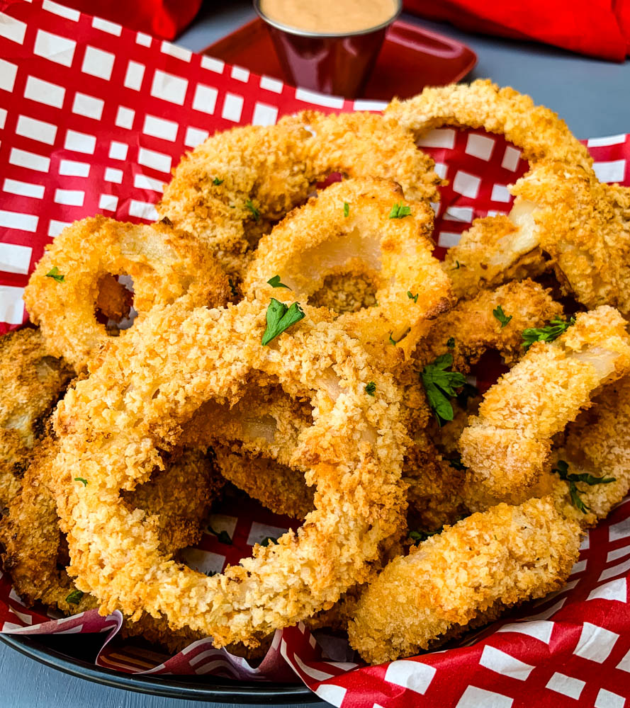 air fryer crispy onion rings in a bowl with a red wrapper