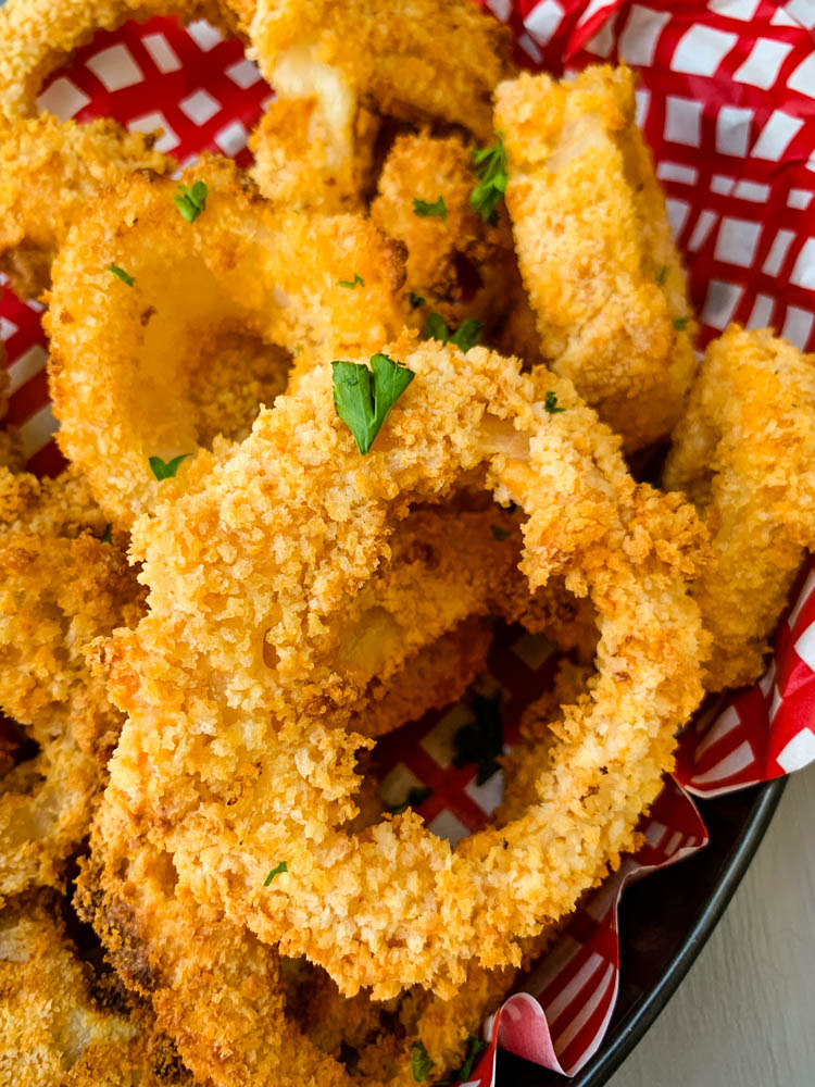 air fryer crispy onion rings in a bowl with a red wrapper