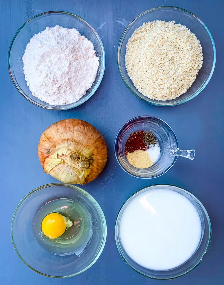all purpose flour, panko breadcrumbs, vidalia onion, egg, buttermilk, and seasoning on a flat surface