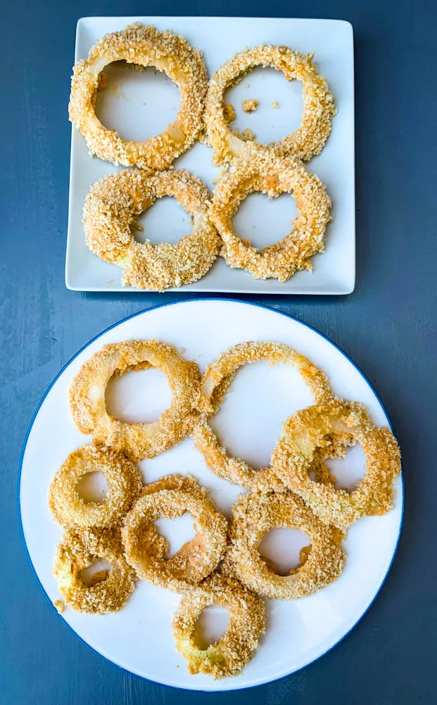 battered uncooked air fryer onion rings on a white plate