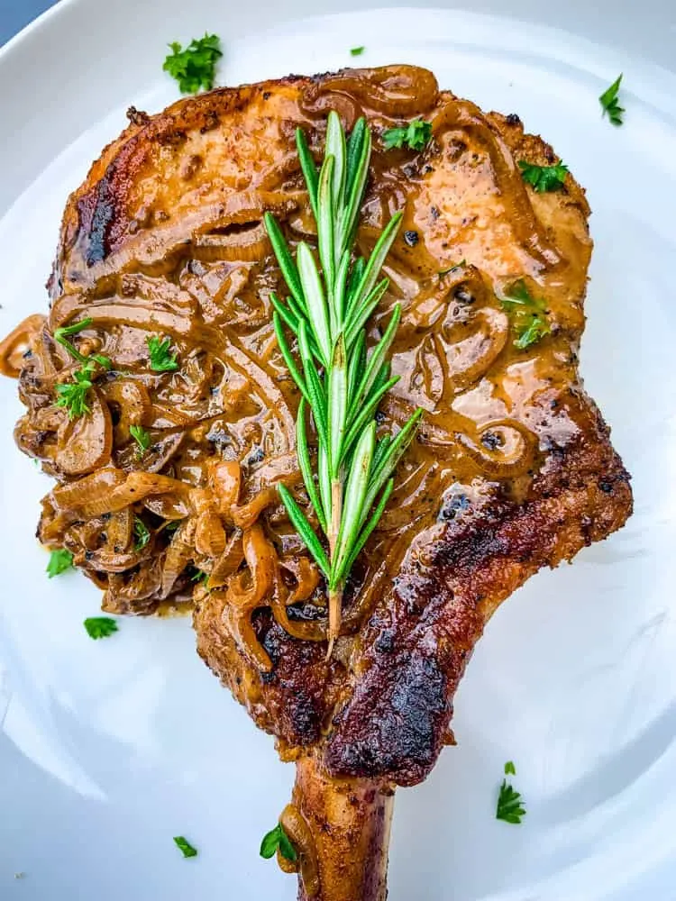 keto smothered pork chops on a white plate