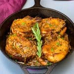 keto low carb smothered pork chops in a cast iron skillet