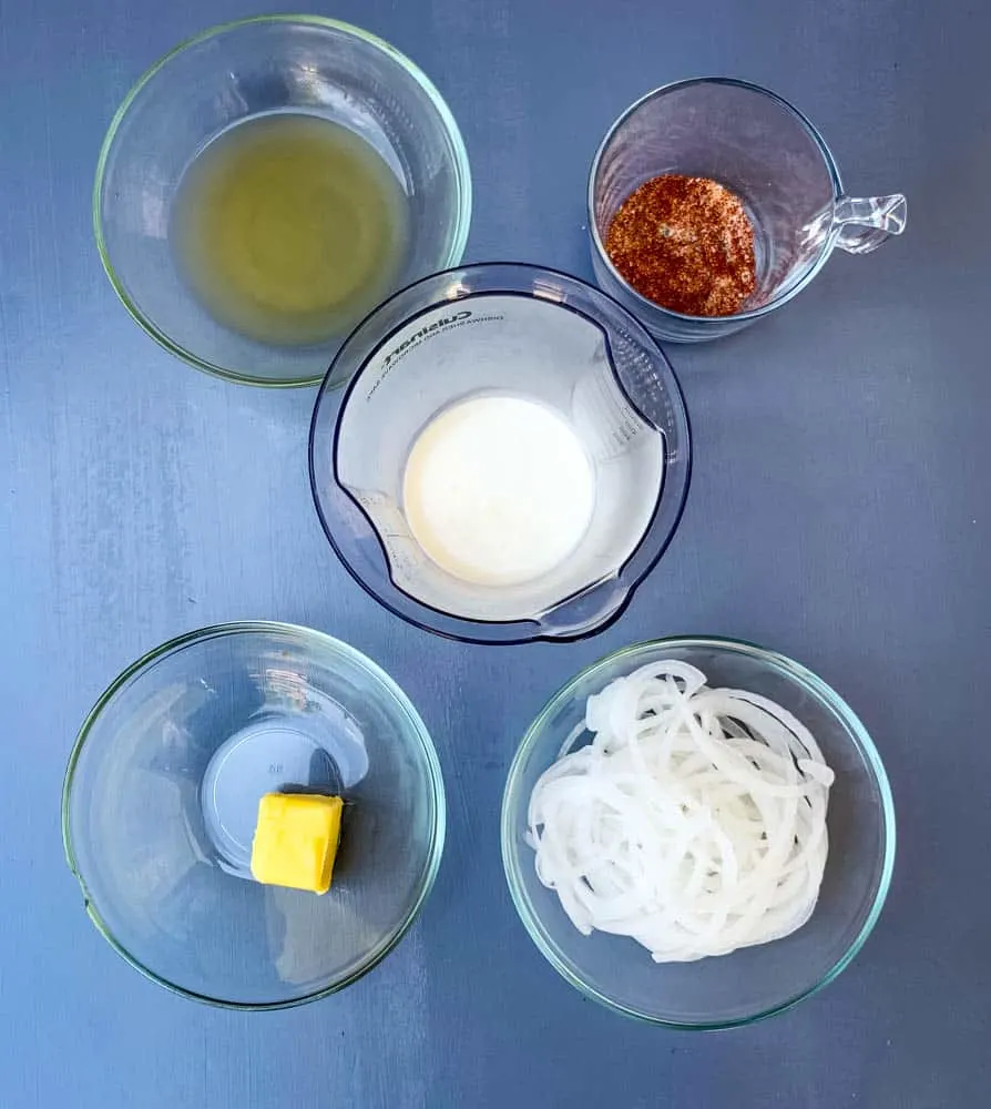 heavy cream, chicken broth, onions, seasoning, and butter in glass bowls