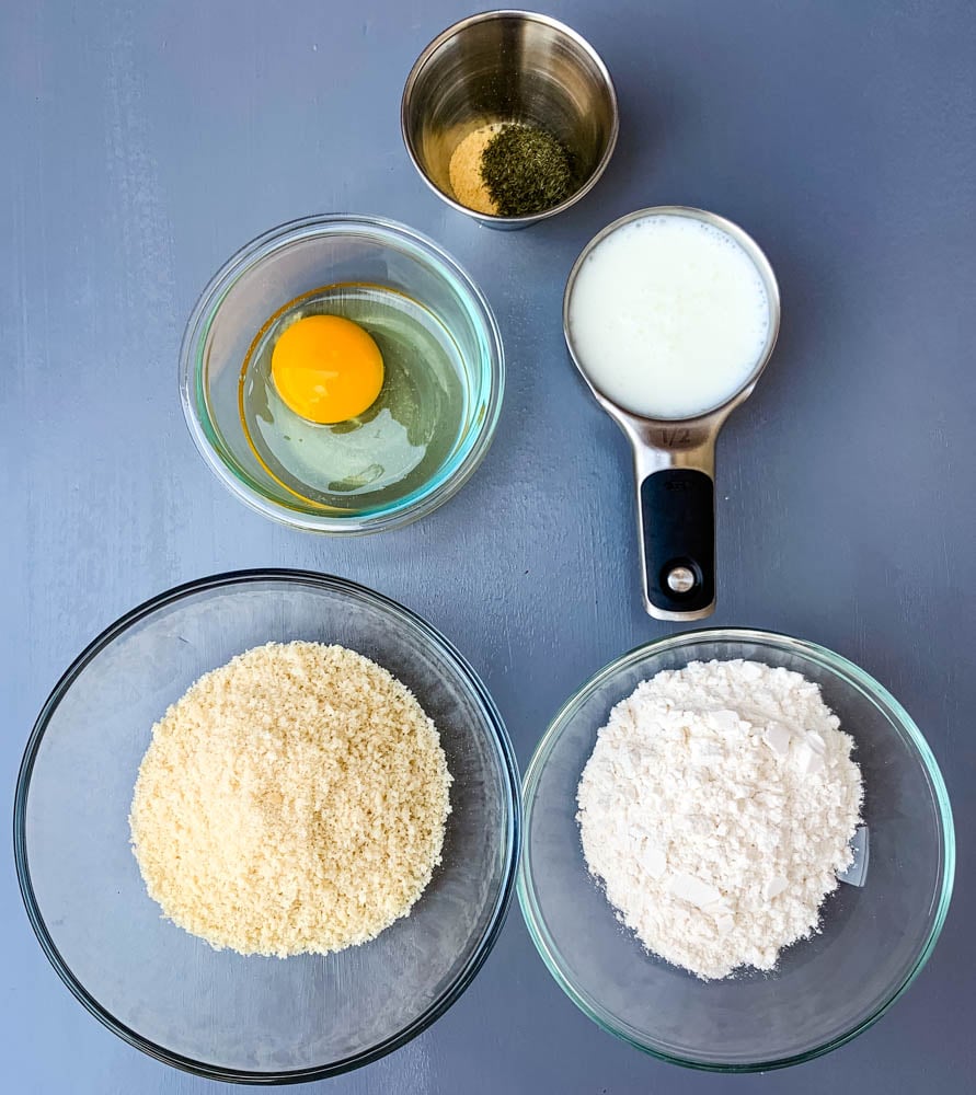panko breadcrumbs, flour, egg, buttermilk, and dill seasoning in separate bowls