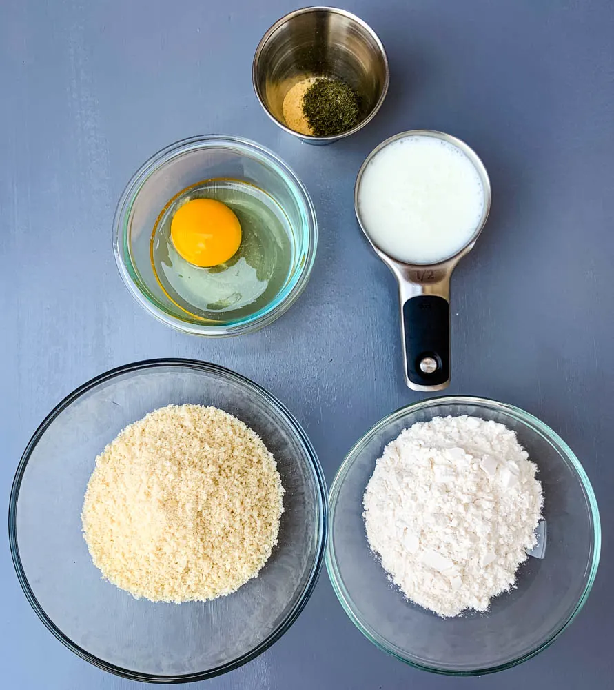 panko breadcrumbs, flour, egg, buttermilk, and dill seasoning in separate bowls