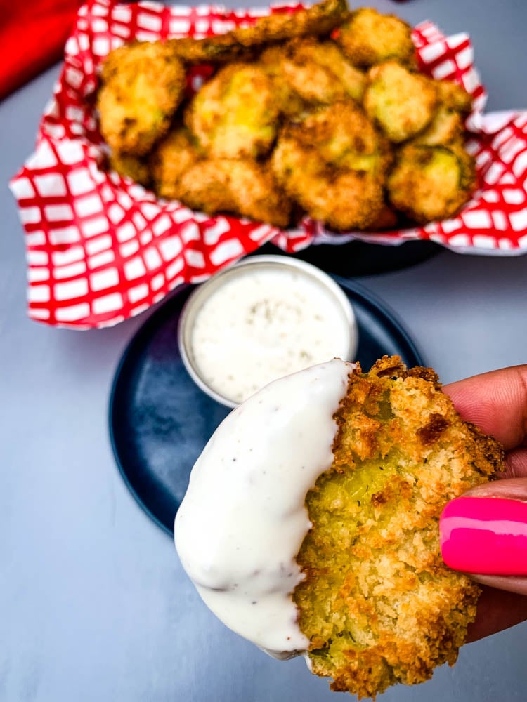 person holding air fryer fried pickle with ranch