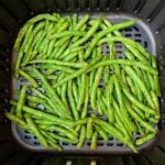 air fryer garlic green beans in an air fryer basket