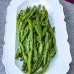 air fryer garlic roasted green beans on a white plate