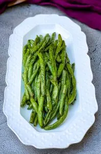 air fryer garlic roasted green beans on a white plate