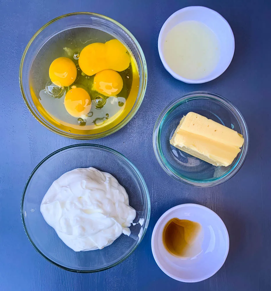 eggs, butter, greek yogurt, and vanilla in bowls for air fryer cake