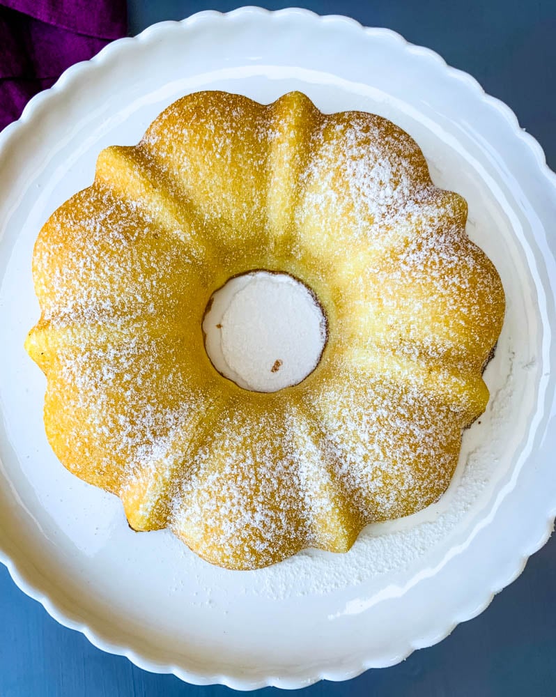 air fryer lemon cake on a white cake stand