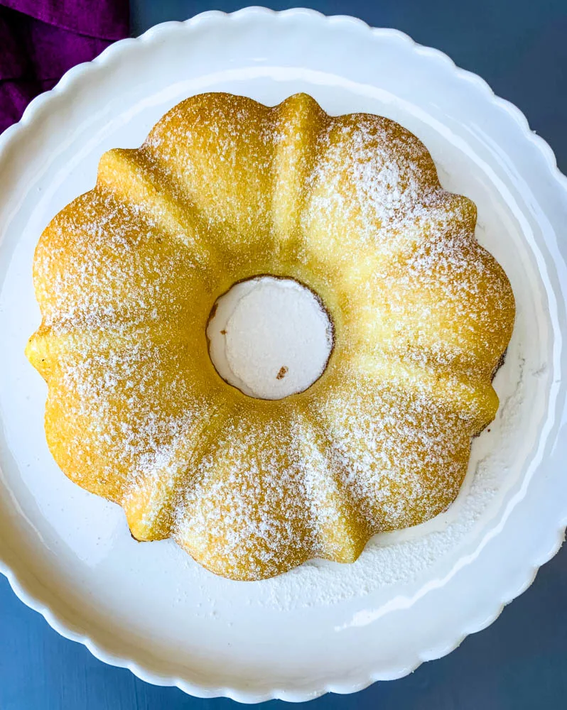 air fryer lemon cake on a white cake stand