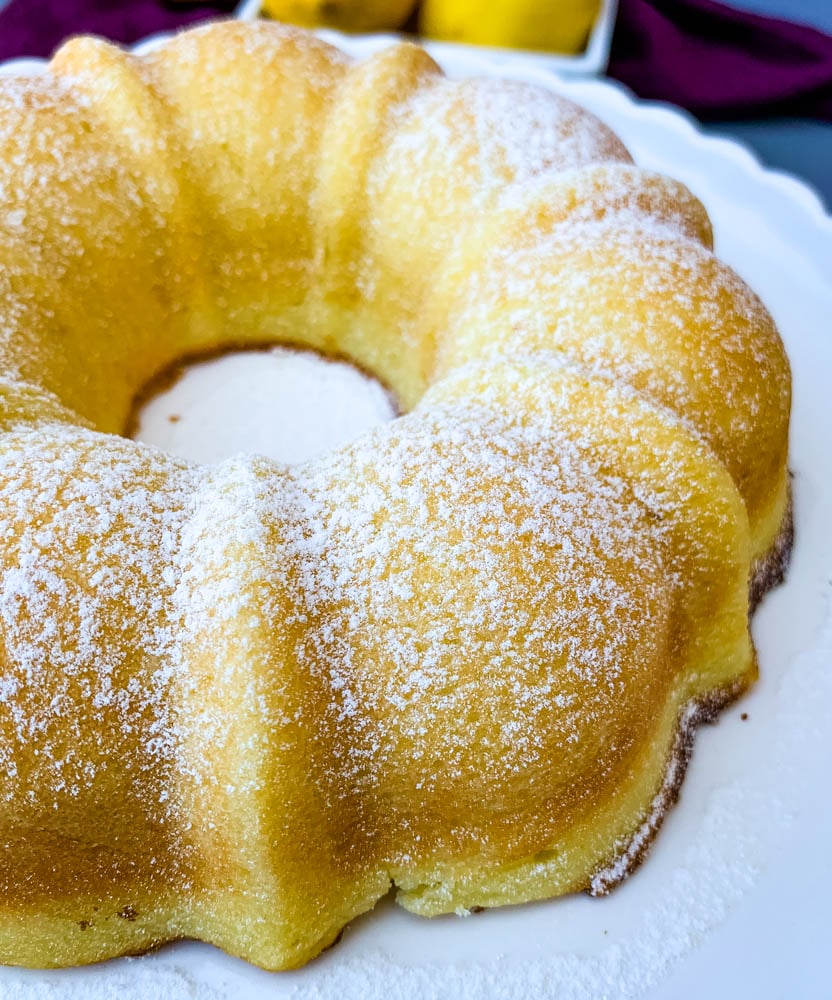 air fryer lemon cake on a white cake stand