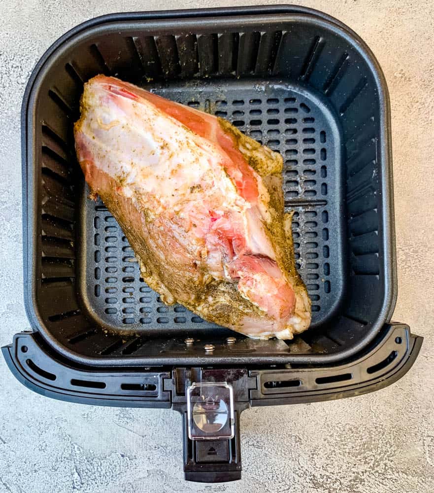 seasoned raw turkey in an air fryer