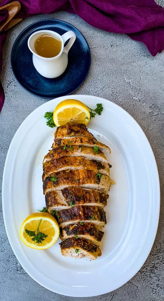 air fryer roasted turkey breast on a white plate