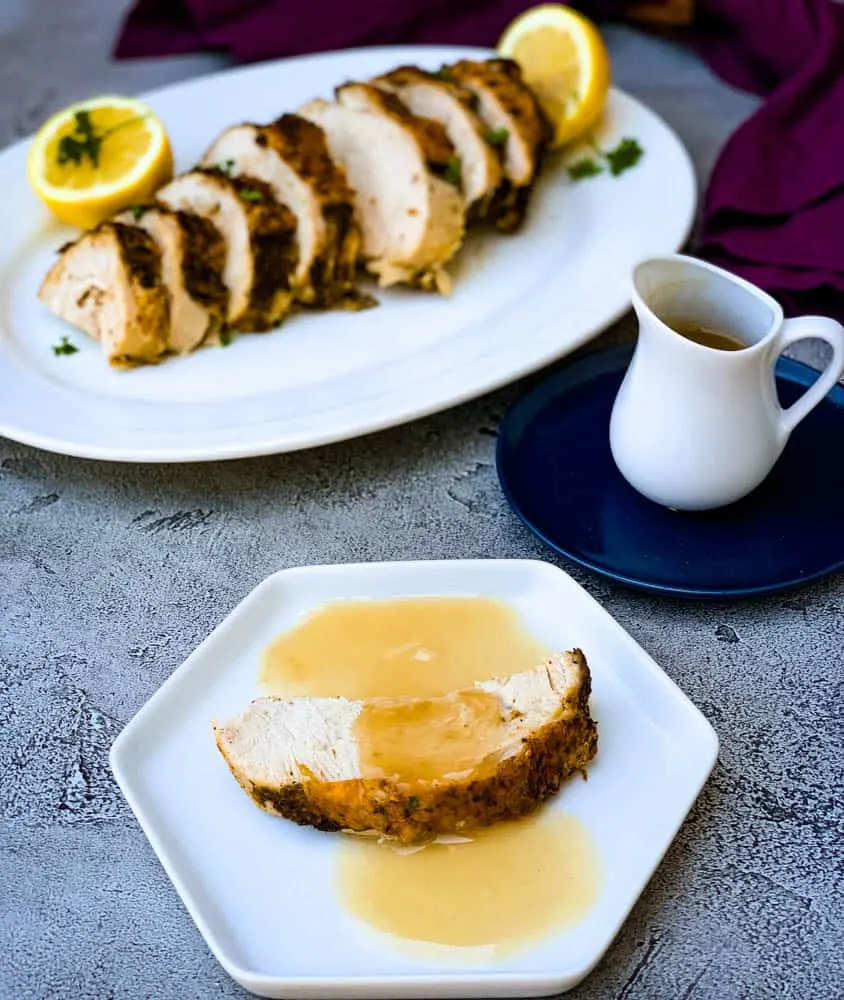 air fryer roasted turkey breast with gravy on a white plate