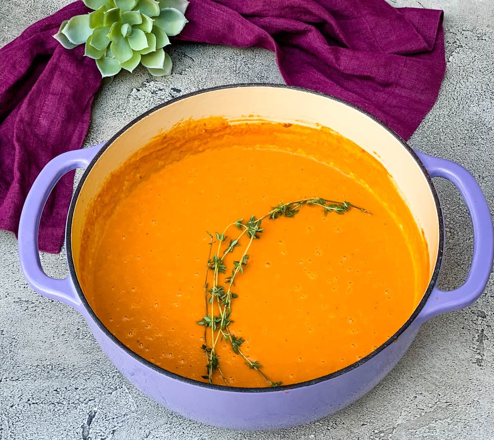 creamy homemade lobster bisque recipe in a purple Dutch oven