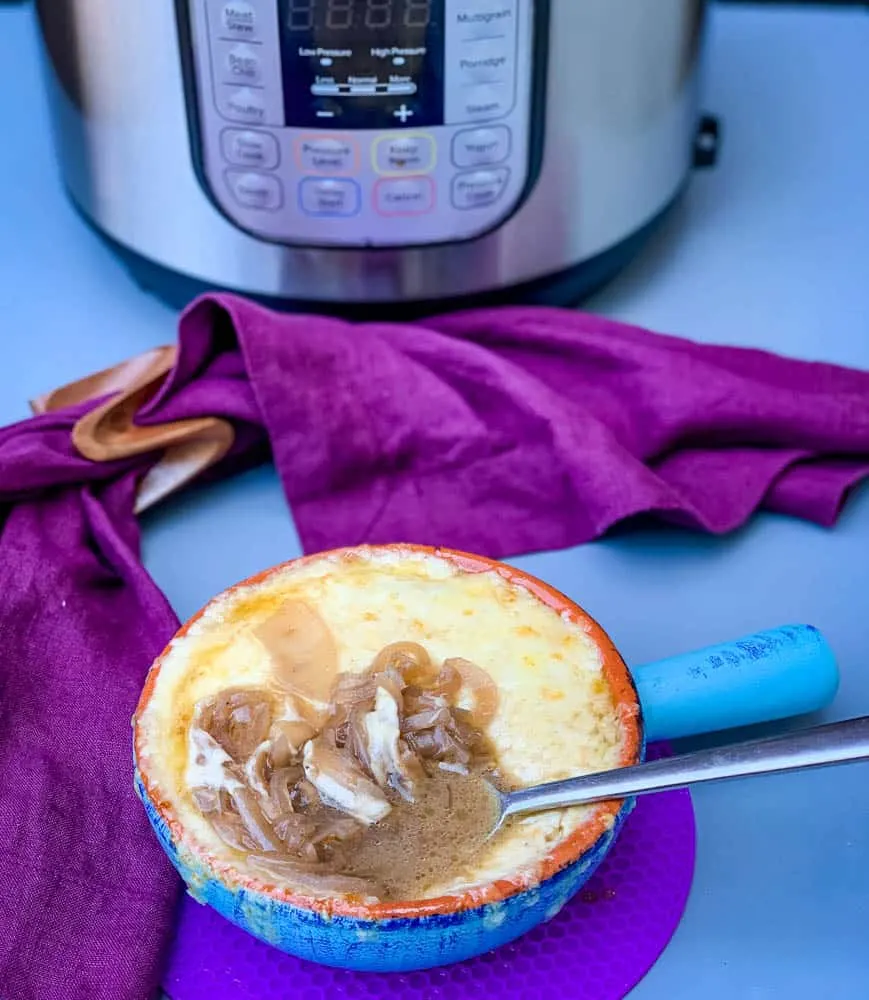 Instant Pot French onion soup in a bowl with cheese