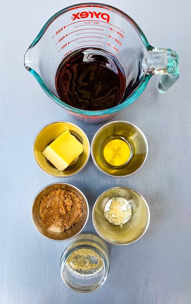 beef broth, butter, olive oil, brown sugar, and seasoning on a flat surface