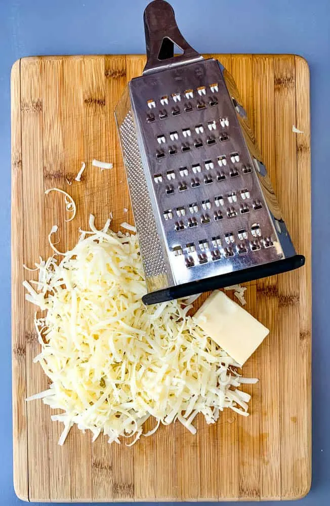 shredded cheese on a cutting board