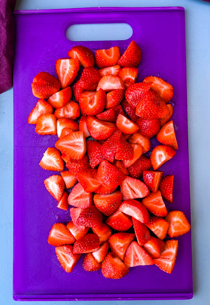 sliced strawberries on a cutting board