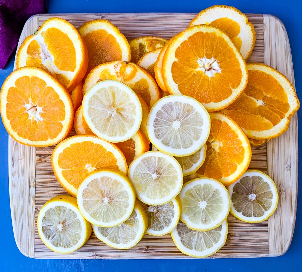 sliced lemons and oranges on a cutting board