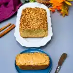 keto low carb zucchini bread on a white plate and a slice of zucchini bread on a blue plate with almond butter