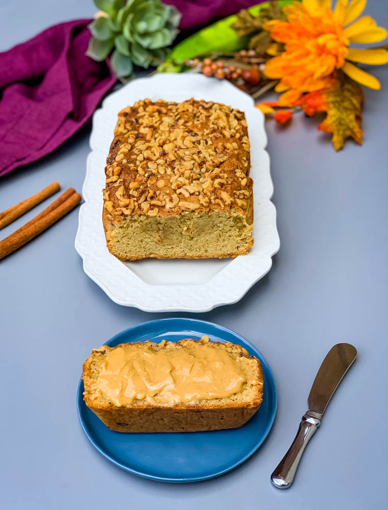 keto low carb zucchini bread on a white plate and a slice of zucchini bread on a blue plate with almond butter