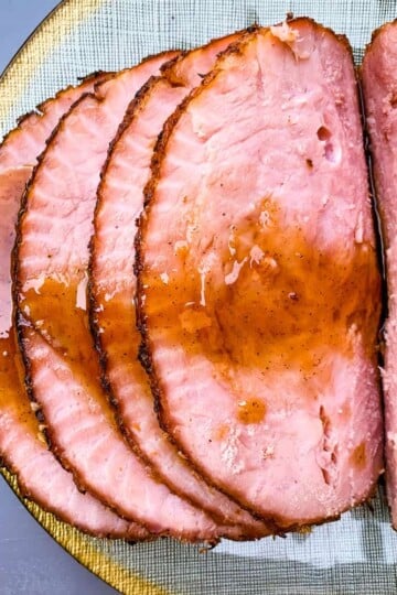 air fryer honey glazed ham on a green and gold plate