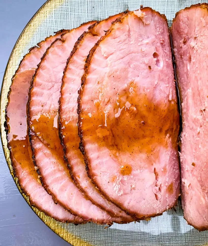 air fryer honey glazed ham on a green and gold plate