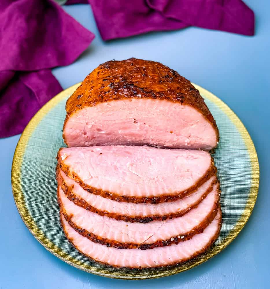 air fryer honey glazed ham on a green and gold plate