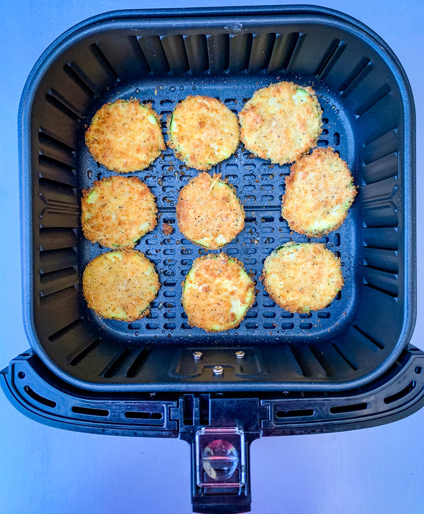 cooked zucchini chips in an air fryer