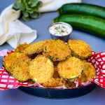 air fryer zucchini chips in a bowl with ranch dressing