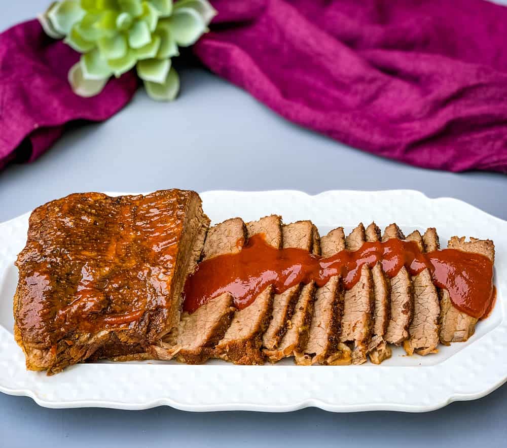 Instant Pot Beef Brisket with BBQ Sauce on a white plate